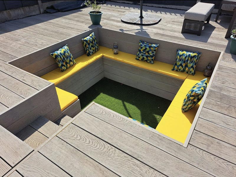 A bespoke sunken seating area with complementing outdoor seat and scatter cushions