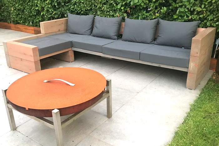 Bespoke outdoor foam and fibre filled cushions for a an outside seating area built from railway sleepers.